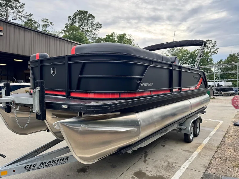 Slide: The Image of 2025 Godfrey Sweetwater 2286 SFLC pontoon boat on trailer, black and red design. - 6
