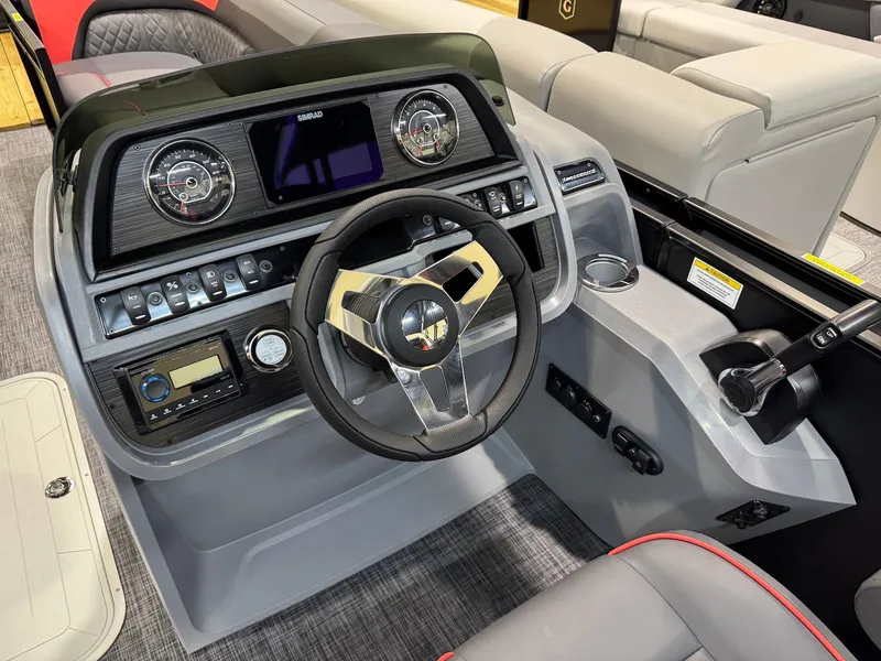 Slide: The Image of 2025 Godfrey Sweetwater 2286 SFLC boat dashboard with steering wheel and control panel. - 9