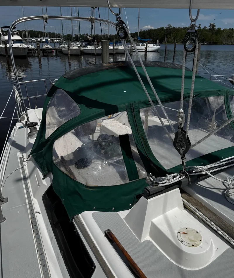 Slide: The Image of 1990 Catalina 34 MK 1.5 sailboat with green canopy docked at marina. - 21