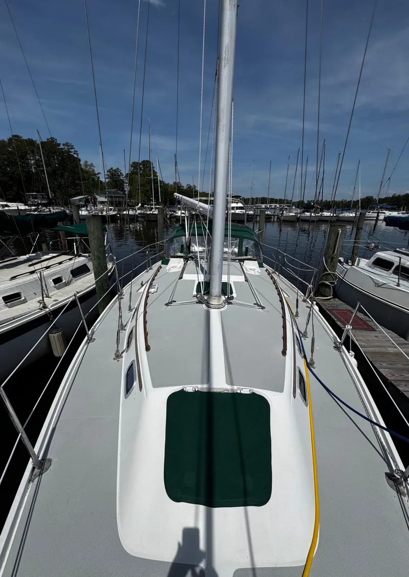 Slide: The Image of 1990 Catalina 34 MK 1.5 sailboat docked at marina, view of deck and mast. - 22