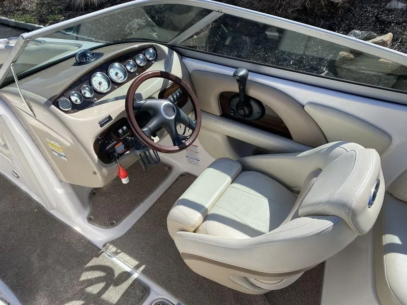 Slide: The Image of 2005 Chaparral 216 Sunesta boat interior with steering wheel and dashboard controls. - 11