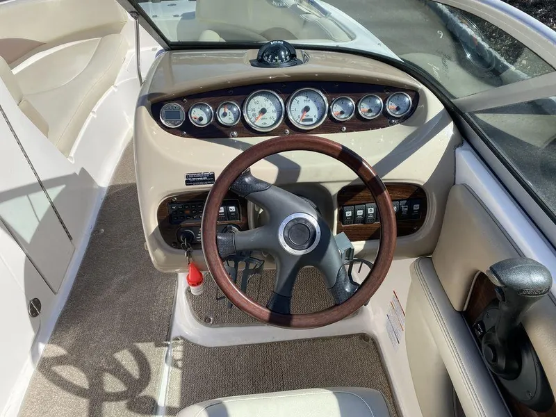 Slide: The Image of 2005 Chaparral 216 Sunesta boat dashboard with gauges and steering wheel. - 12