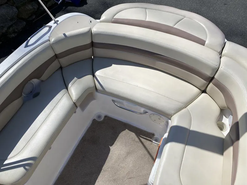 Slide: The Image of 2005 Chaparral 216 Sunesta boat interior with beige seating and carpeted floor. - 17