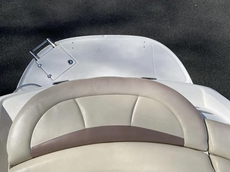 Slide: The Image of 2005 Chaparral 216 Sunesta boat interior with beige and brown seating. - 18