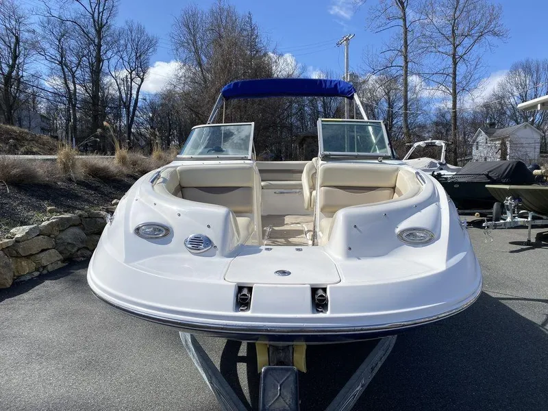 Slide: The Image of 2005 Chaparral 216 Sunesta boat on trailer, parked outdoors, clear sky background. - 8