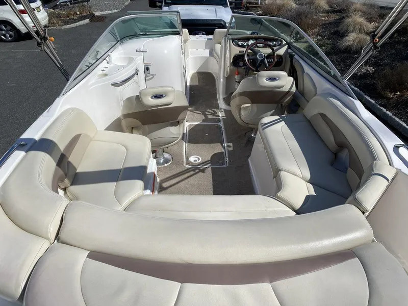 Slide: The Image of 2005 Chaparral 216 Sunesta boat interior with spacious seating and steering console. - 9