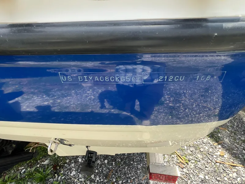 Slide: The Image of 2006 Bayliner 212 boat hull identification number on blue and white exterior. - 7