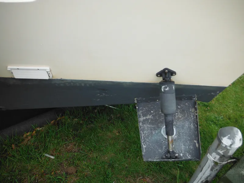 Slide: The Image of 2002 Parker 2520 Modified Vee Sport Cabin boat's trim tab on grassy surface. - 11