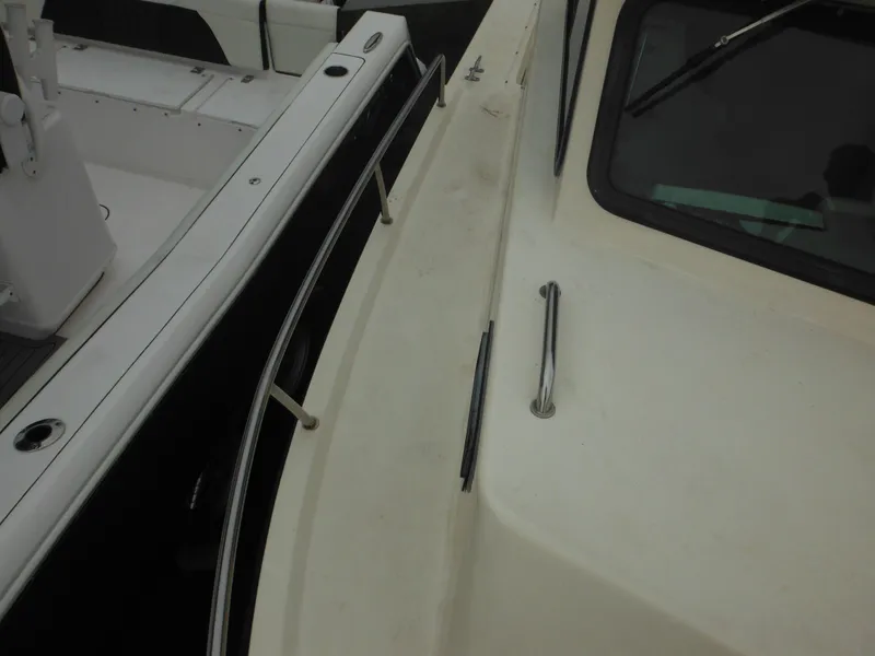 Slide: The Image of 2002 Parker 2520 Modified Vee Sport Cabin boat deck and railing detail. - 24