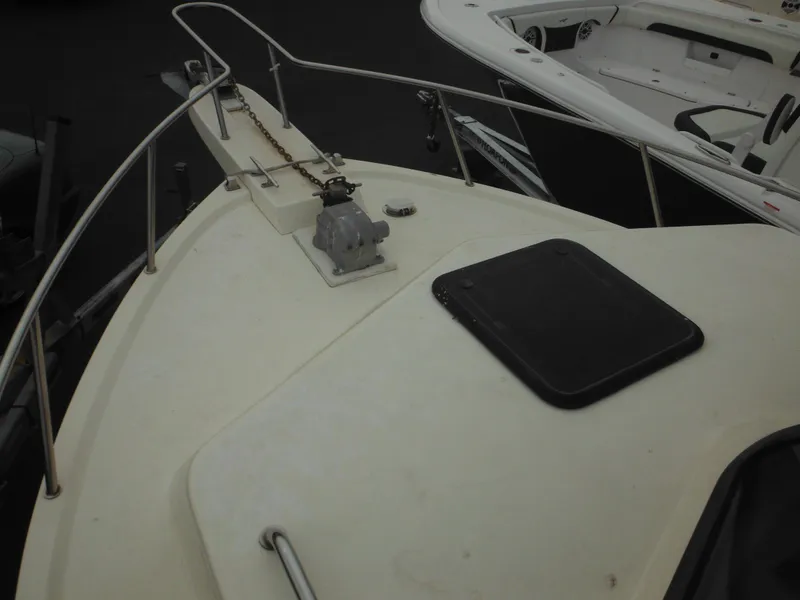 Slide: The Image of Bow of 2002 Parker 2520 Modified Vee Sport Cabin boat with anchor and hatch. - 27