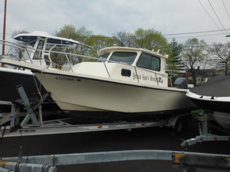 Slide: The Image of 2002 Parker 2520 Modified Vee Sport Cabin boat on trailer, parked outdoors. - 3