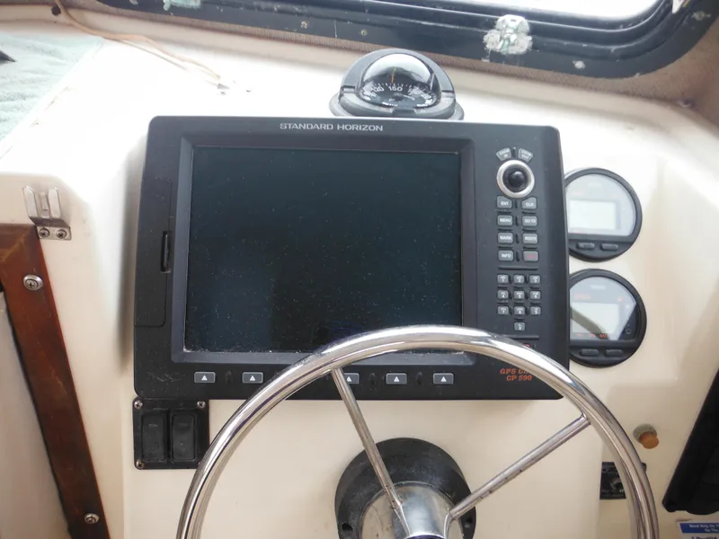 Slide: The Image of Steering wheel and navigation system of 2002 Parker 2520 Modified Vee Sport Cabin boat. - 32