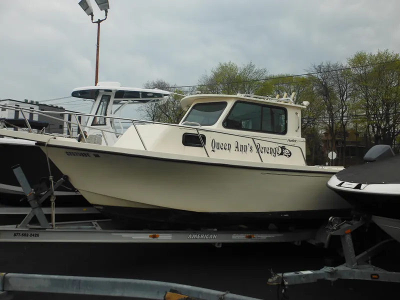 Slide: The Image of 2002 Parker 2520 Modified Vee Sport Cabin boat on trailer, named "Queen Ann's Revenge." - 4