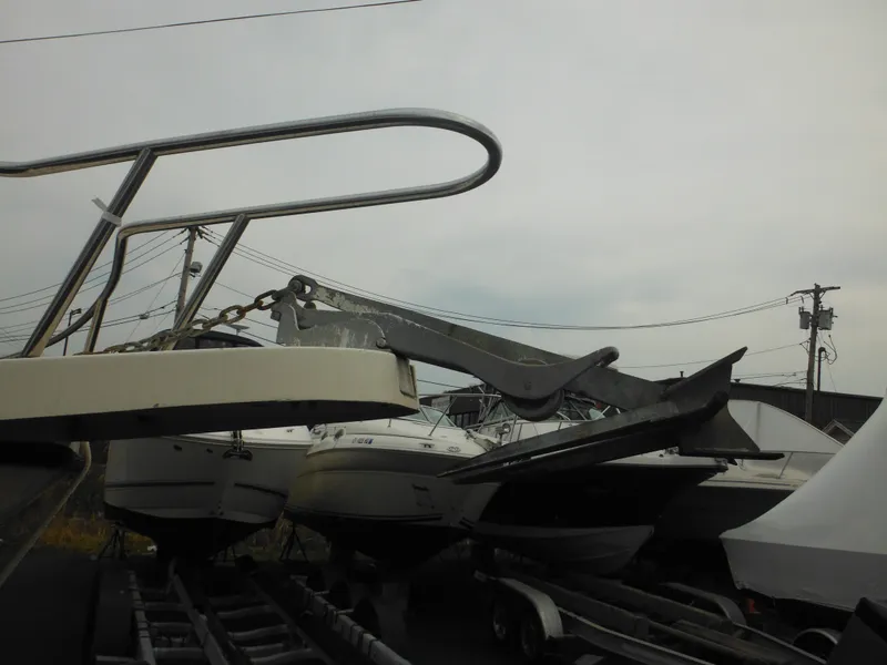Slide: The Image of 2002 Parker 2520 Modified Vee Sport Cabin boat on trailer, overcast sky background. - 5