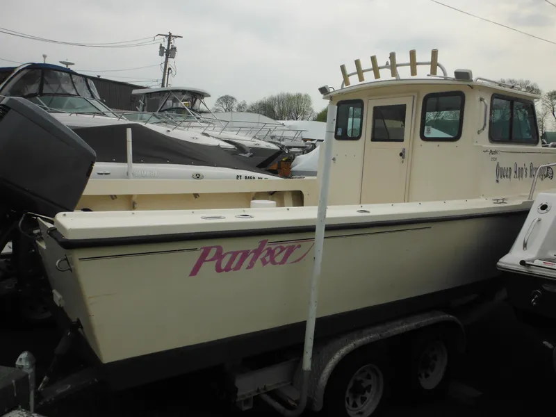 Slide: The Image of 2002 Parker 2520 Modified Vee Sport Cabin boat on trailer in marina. - 6