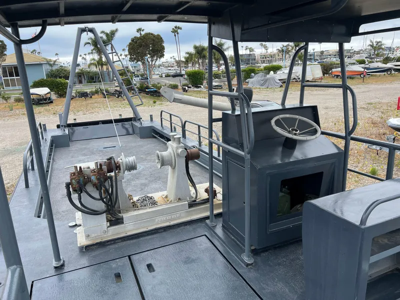 Slide: The Image of 2004 SeaArk 35 Aluminum Work Boat with A-Frame, docked, showcasing deck and equipment. - 4