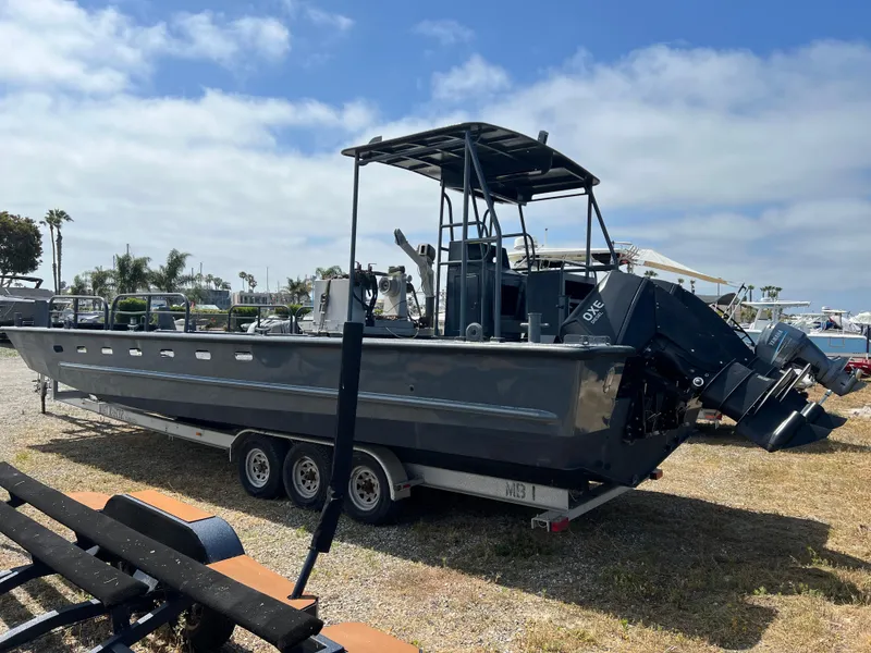 Slide: The Image of 2004 SeaArk 35 Aluminum Work Boat with A-Frame on trailer, parked outdoors. - 6