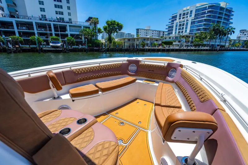 Slide: The Image of 2023 Sea Pro 320 DLX Offshore boat interior with luxurious seating and waterfront view. - 11