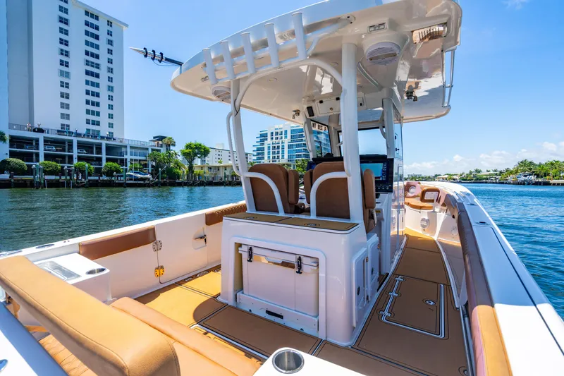 Slide: The Image of 2023 Sea Pro 320 DLX Offshore boat on water, featuring spacious deck and modern design. - 15