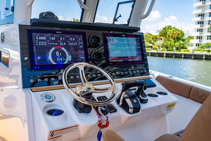 Slide: The Image of 2023 Sea Pro 320 DLX Offshore boat dashboard with advanced navigation displays and controls. - 17