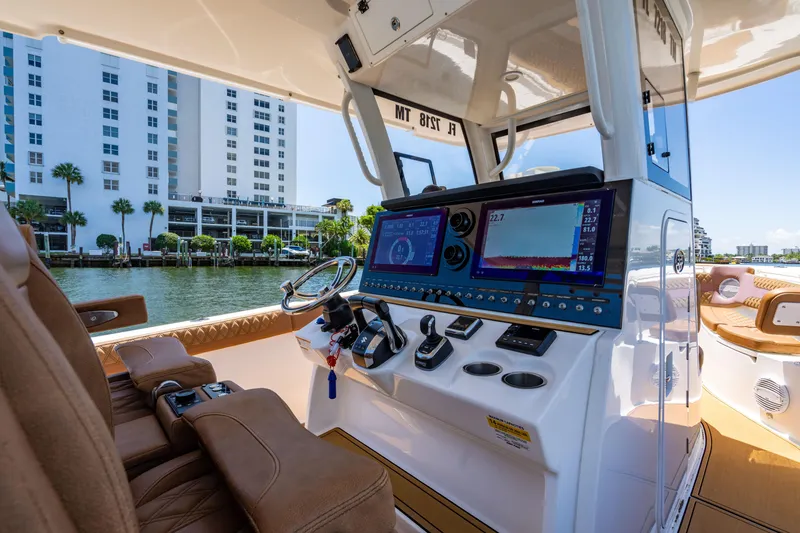 Slide: The Image of 2023 Sea Pro 320 DLX Offshore boat interior with modern navigation system and luxurious seating. - 18