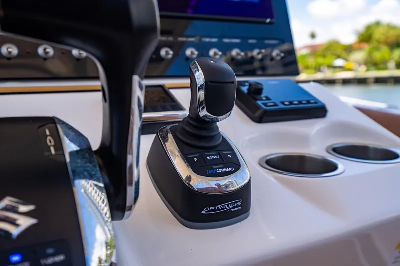 Slide: The Image of 2023 Sea Pro 320 DLX Offshore boat control panel with joystick and throttle. - 23