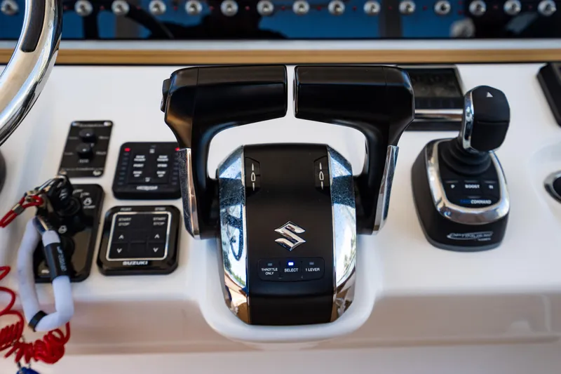 Slide: The Image of Control panel of 2023 Sea Pro 320 DLX Offshore boat with Suzuki throttle. - 24