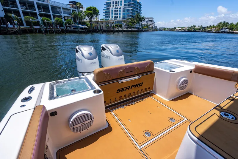 Slide: The Image of 2023 Sea Pro 320 DLX Offshore boat interior with dual engines on a sunny day. - 3