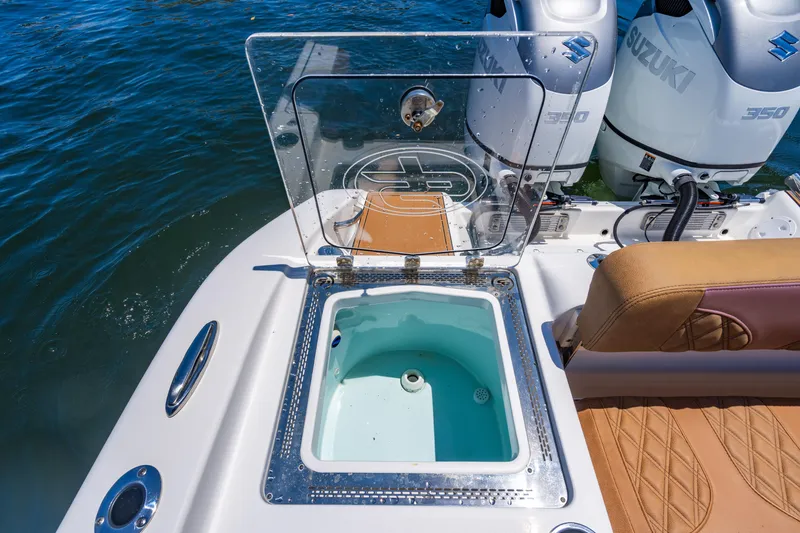 Slide: The Image of 2023 Sea Pro 320 DLX Offshore boat with open livewell and dual Suzuki engines. - 38