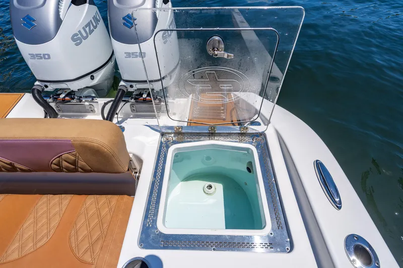 Slide: The Image of 2023 Sea Pro 320 DLX Offshore boat with open livewell and dual Suzuki 350 engines. - 39