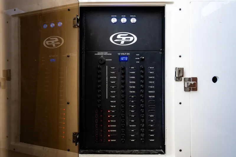 Slide: The Image of Electrical panel of 2023 Sea Pro 320 DLX Offshore boat with control switches. - 44