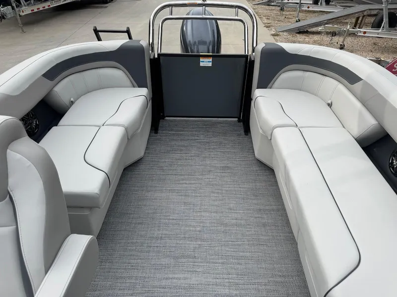 Slide: The Image of 2025 Godfrey Sweetwater 2086 SB boat interior with gray seating and carpeted floor. - 12
