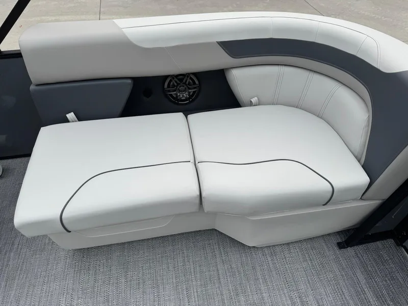 Slide: The Image of 2025 Godfrey Sweetwater 2086 SB boat interior with cushioned seating and speaker. - 13