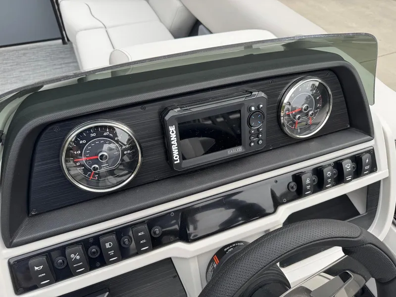 Slide: The Image of Dashboard of 2025 Godfrey Sweetwater 2086 SB with gauges and Lowrance display. - 16