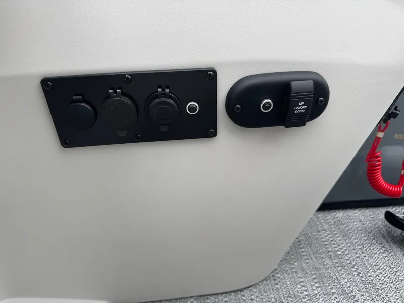 Slide: The Image of Control panel on 2025 Godfrey Sweetwater 2086 SB boat, featuring switches and outlets. - 18