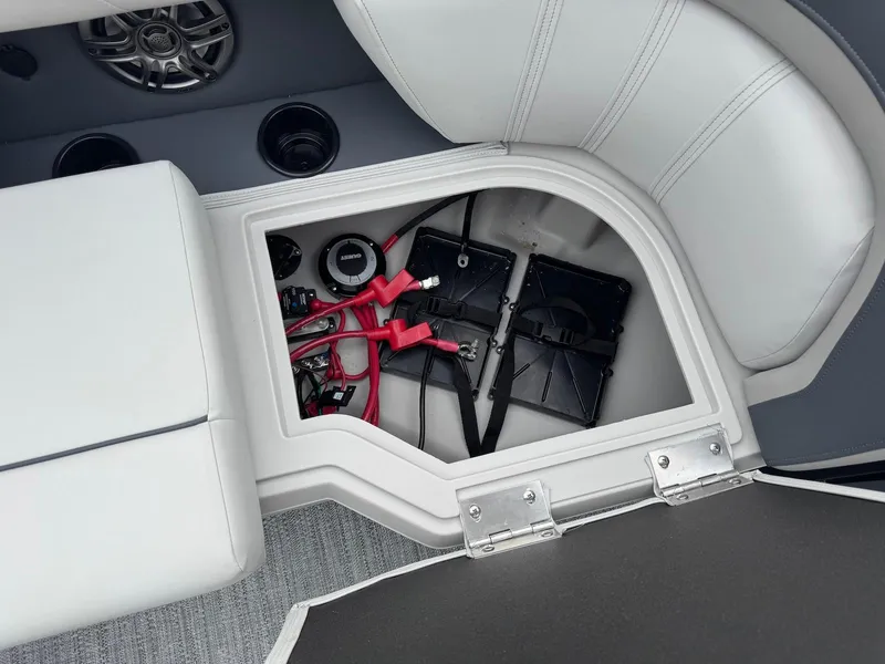 Slide: The Image of Battery compartment of 2025 Godfrey Sweetwater 2086 SB boat with wiring and speaker. - 21