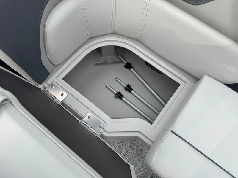 Slide: The Image of Storage compartment in 2025 Godfrey Sweetwater 2086 SB boat with metal rods inside. - 22