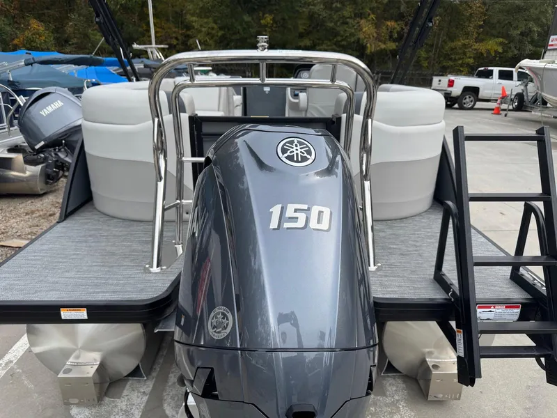 Slide: The Image of 2025 Godfrey Sweetwater 2086 SB pontoon boat with Yamaha 150 engine, docked outdoors. - 4