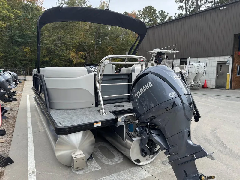 Slide: The Image of 2025 Godfrey Sweetwater 2086 SB pontoon boat with Yamaha outboard motor, parked outdoors. - 5