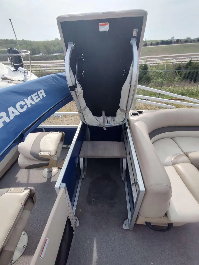Slide: The Image of 2016 Sun Tracker Fishin' Barge 22 DLX with open storage compartment and seating. - 8