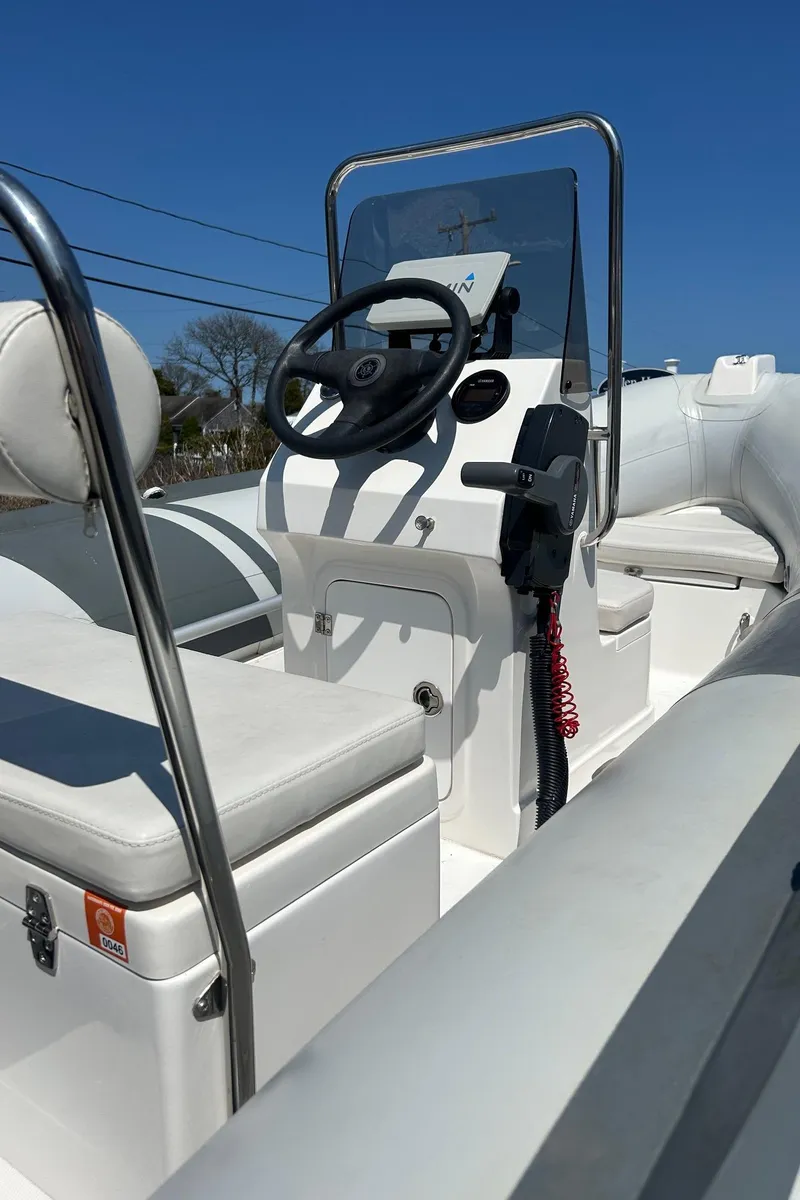 Slide: The Image of 2021 North Atlantic Inflatables RIB420 boat interior with steering console and seating. - 10