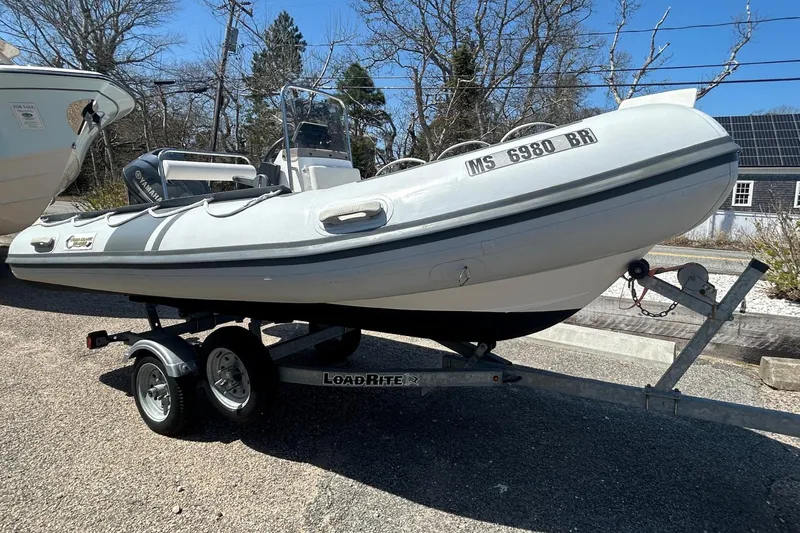 Slide: The Image of 2021 North Atlantic Inflatables RIB420 boat on trailer, parked outdoors. - 4