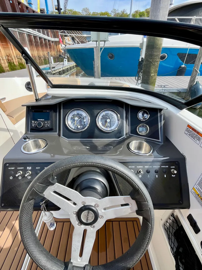 Slide: The Image of 2022 Bayliner VR5 Bowrider OB dashboard with steering wheel and gauges. - 13