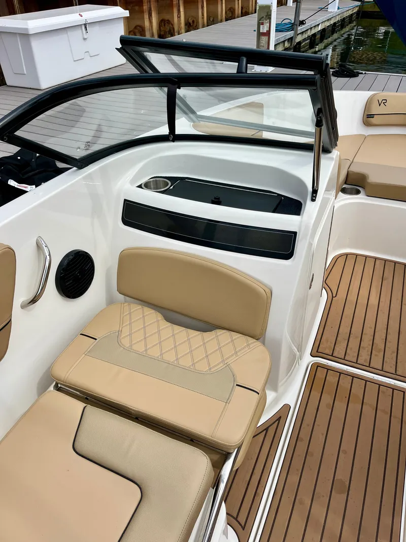 Slide: The Image of 2022 Bayliner VR5 Bowrider OB interior with tan seating and wood accents. - 15