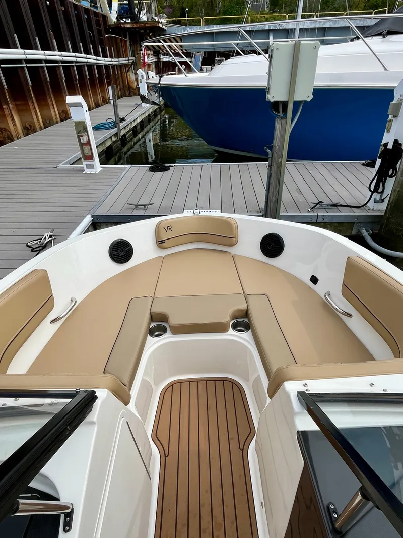 Slide: The Image of 2022 Bayliner VR5 Bowrider OB with tan seating, docked at a marina. - 16