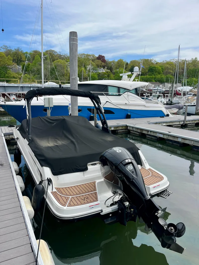 Slide: The Image of 2022 Bayliner VR5 Bowrider OB docked at marina with covered seating area. - 21