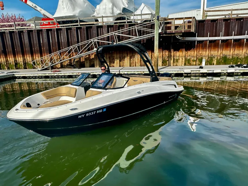 Slide: The Image of 2022 Bayliner VR5 Bowrider OB in marina, sleek design, calm water. - 3