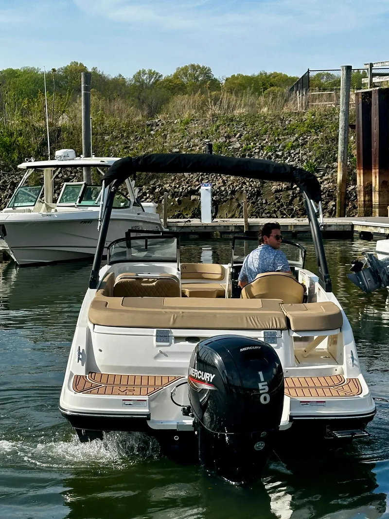 Slide: The Image of 2022 Bayliner VR5 Bowrider OB with Mercury engine in a marina setting. - 5