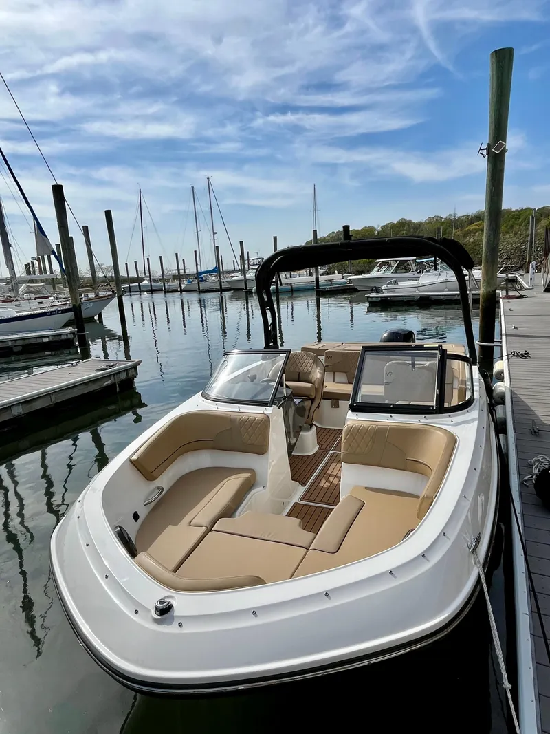 Slide: The Image of 2022 Bayliner VR5 Bowrider OB docked, featuring spacious seating and sleek design. - 8