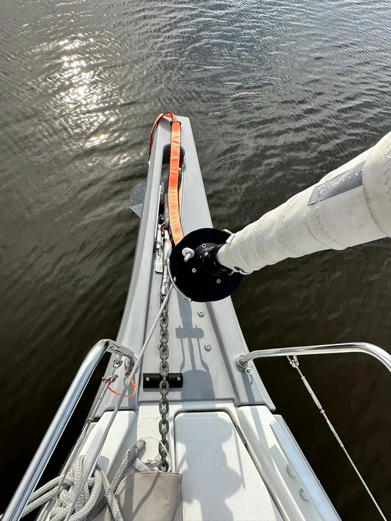 Slide: The Image of Bow of 2022 Beneteau Oceanis 46.1 sailboat with anchor chain and calm water. - 11